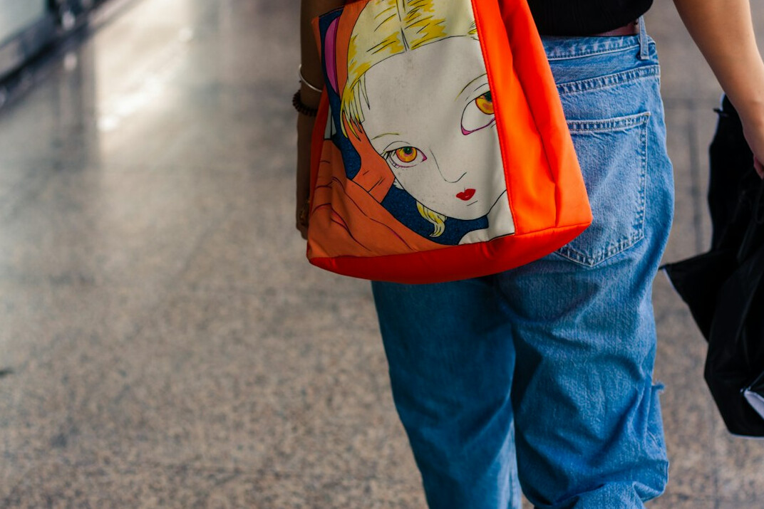 woman hiding item in bag