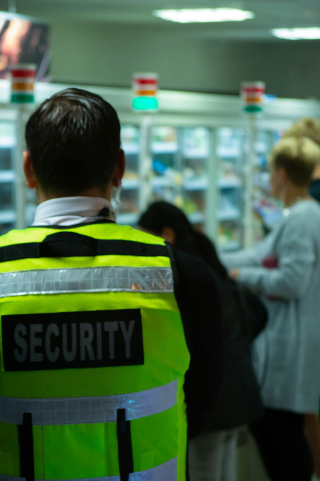 store security guard monitoring aisles
