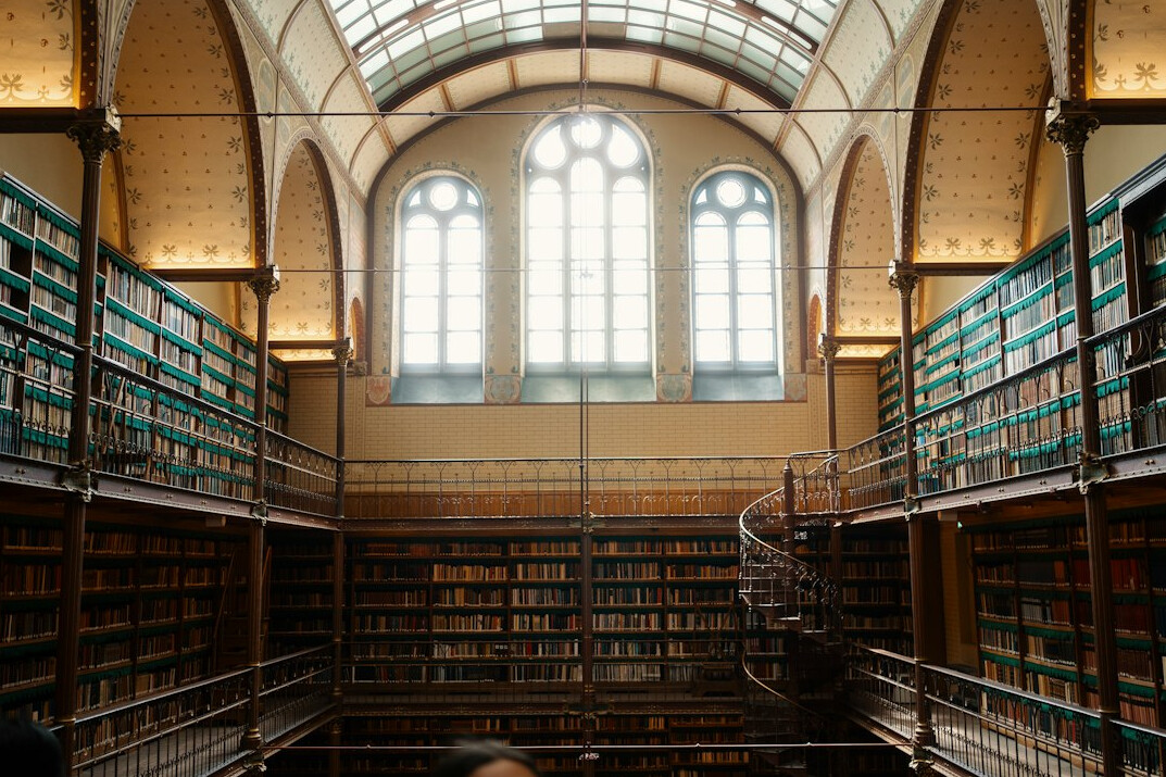 Atmospheric old library interior with tall wooden bookshelves